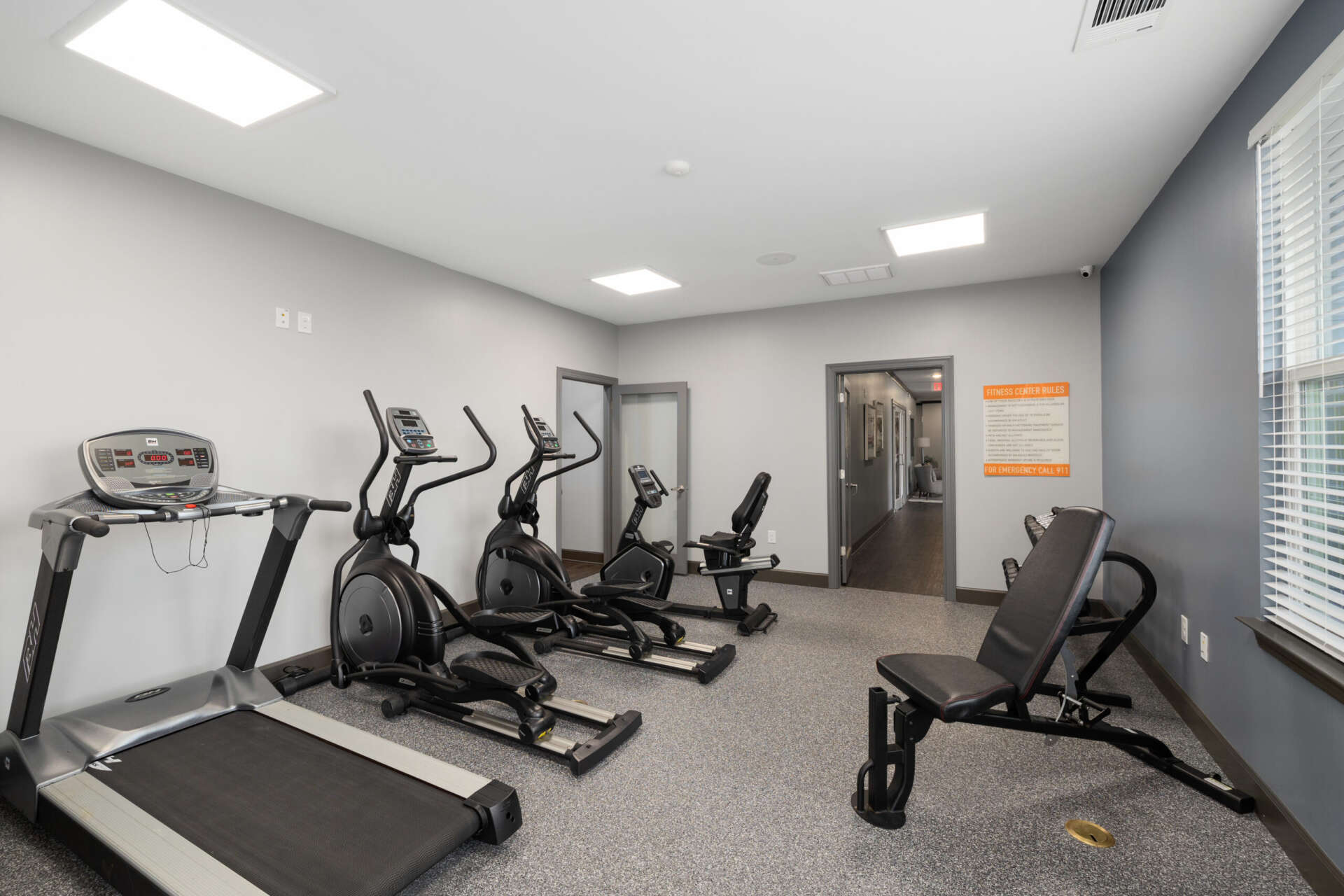 Le Jolliet's fitness center equipped with a treadmill and ellipticals.